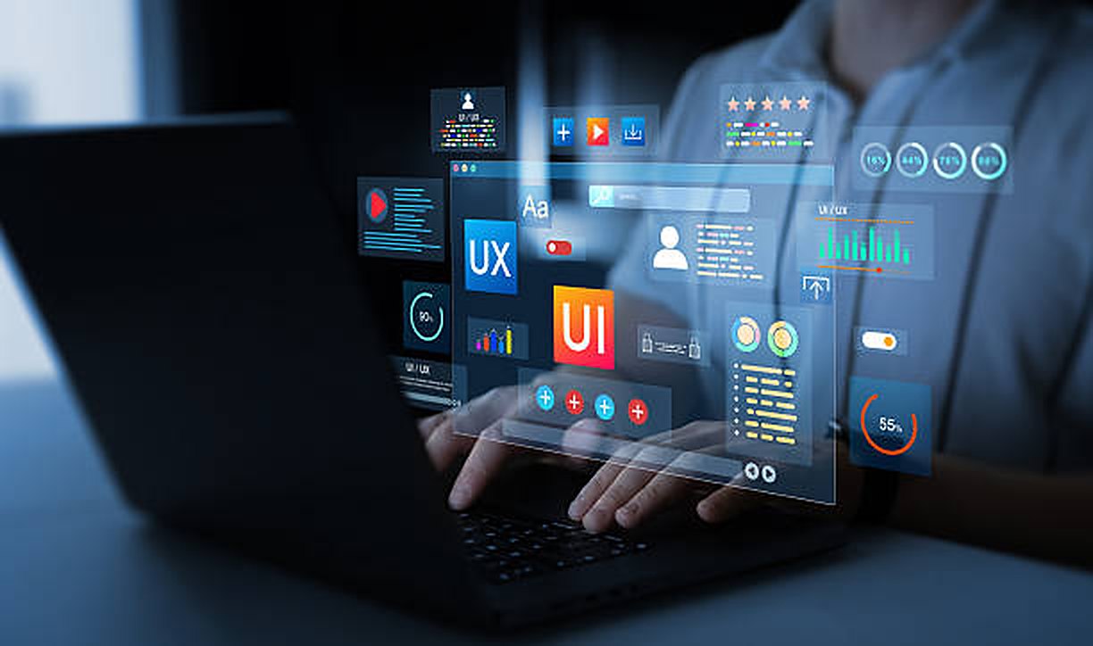 Designer building a UI/UX dashboard for a website on a laptop